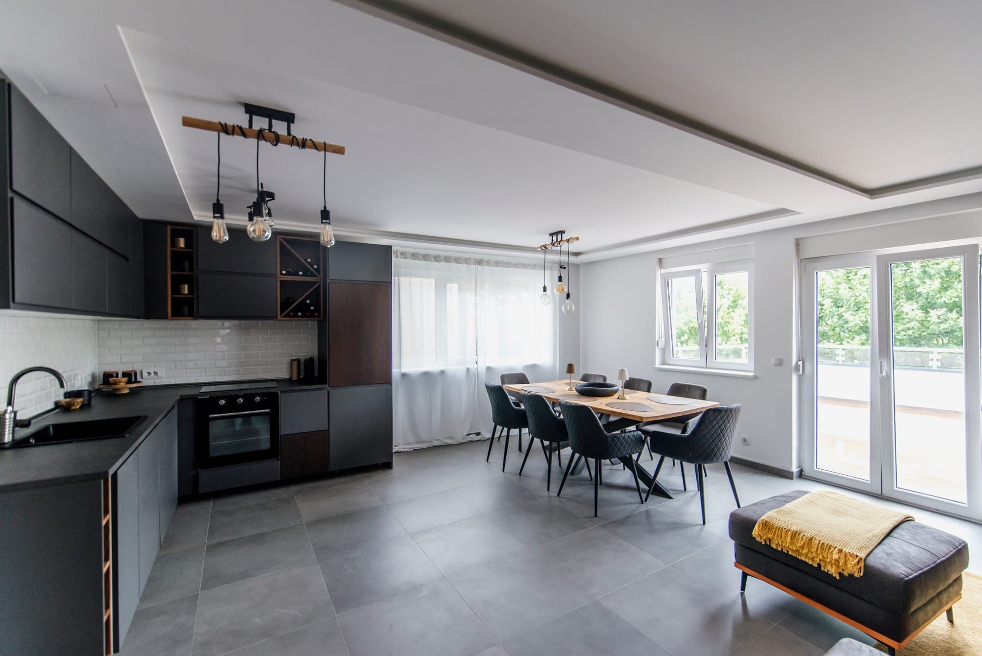 Contemporary dining area with a wall of large windows and natural light
