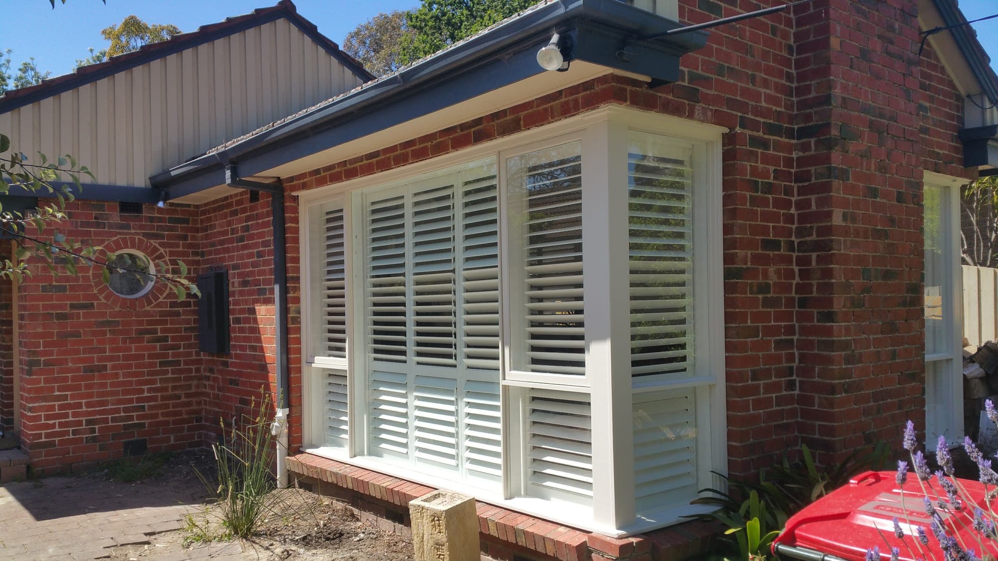Bay window fitted with white plantation shutters